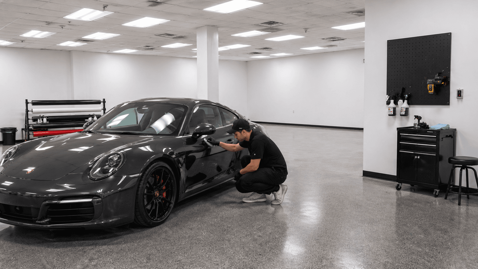 Technician applying ceramic coating to a Porsche
